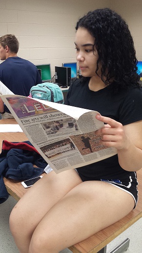 Student reads a recent article about the conflict