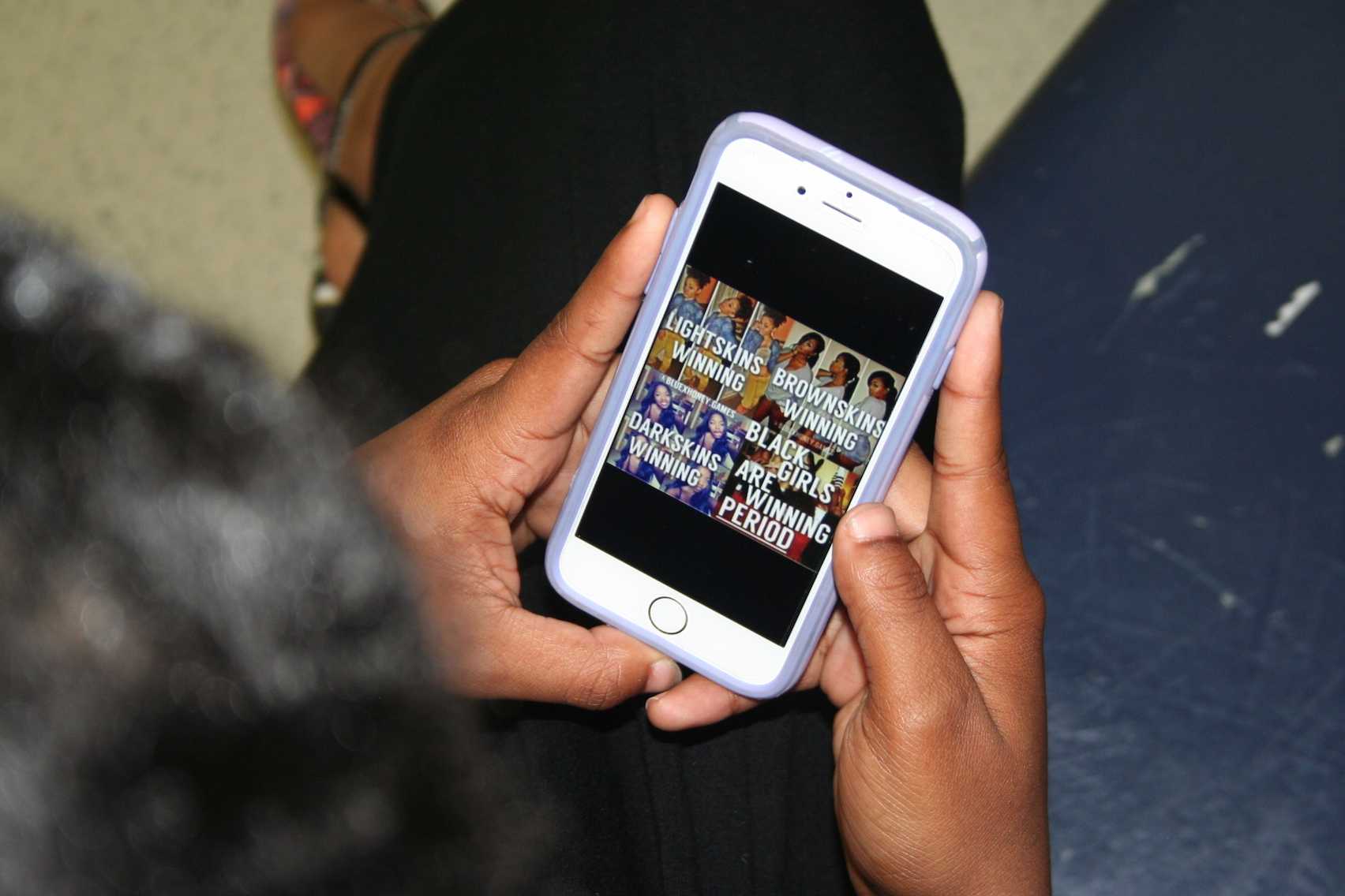 Maya Canaday looks at picture on social media uplifting girls of color
