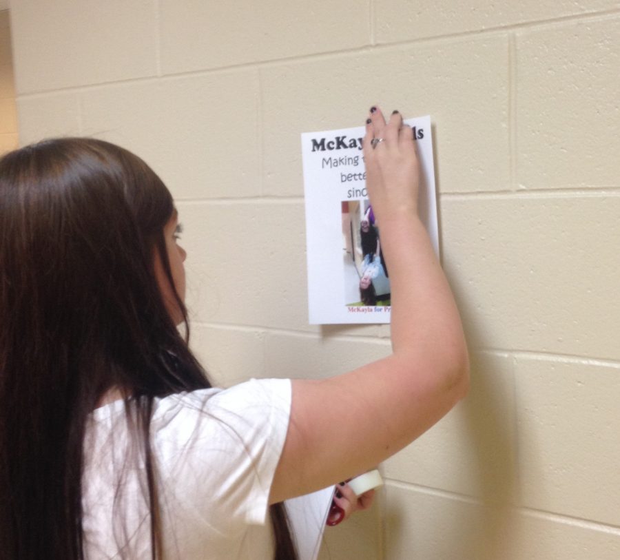 McKayla Mills puts up the newest poster of her presidential bid.