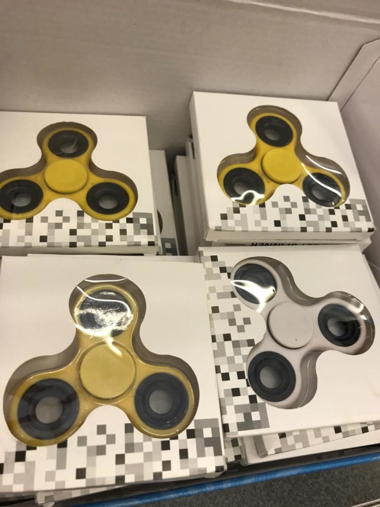 This is a box full of fidget spinners for sale at 7-11
