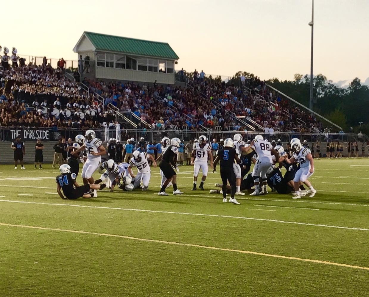 Lafayette and Warhill battle late in the first quarter on Friday, September 15th as Warhills home stands look on.