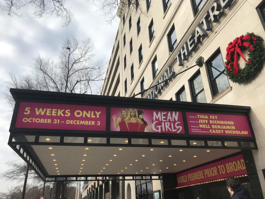 Eye-catching signs hang outside of the National Theatre to promote Mean Girls: The Musical.