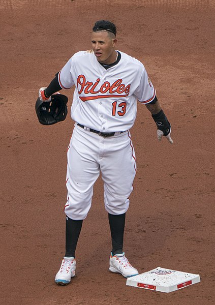 Manny Machado looks at his former teammates after he steals second base.