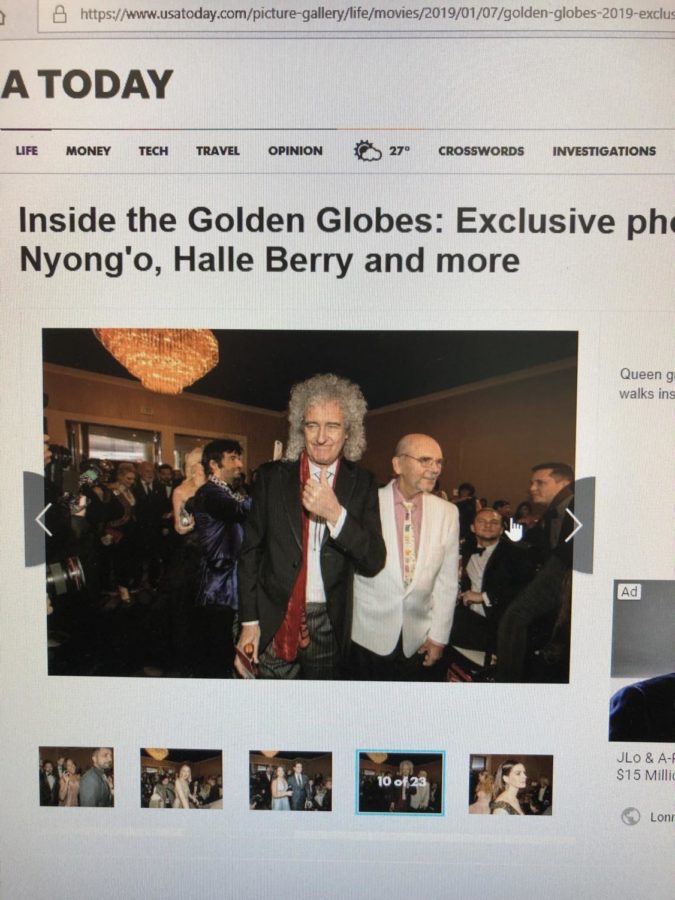 As the actors, actresses, musicians, and directors crowded the after party event, Queen guitarist Brian May gives a thumbs up to the camera and a dashing smile.