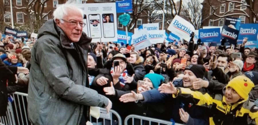 Bernie Sanders shaking hands with supporters at his rally.