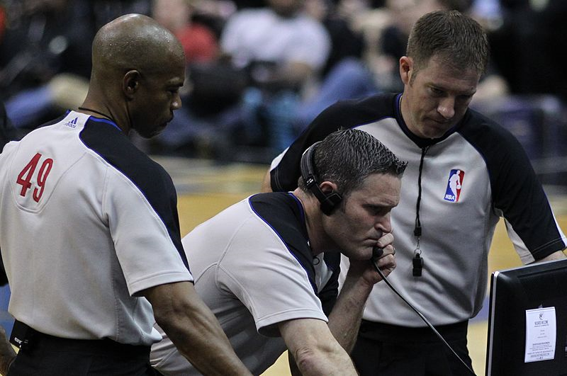 The referees watch a replay to see if they made the correct call.