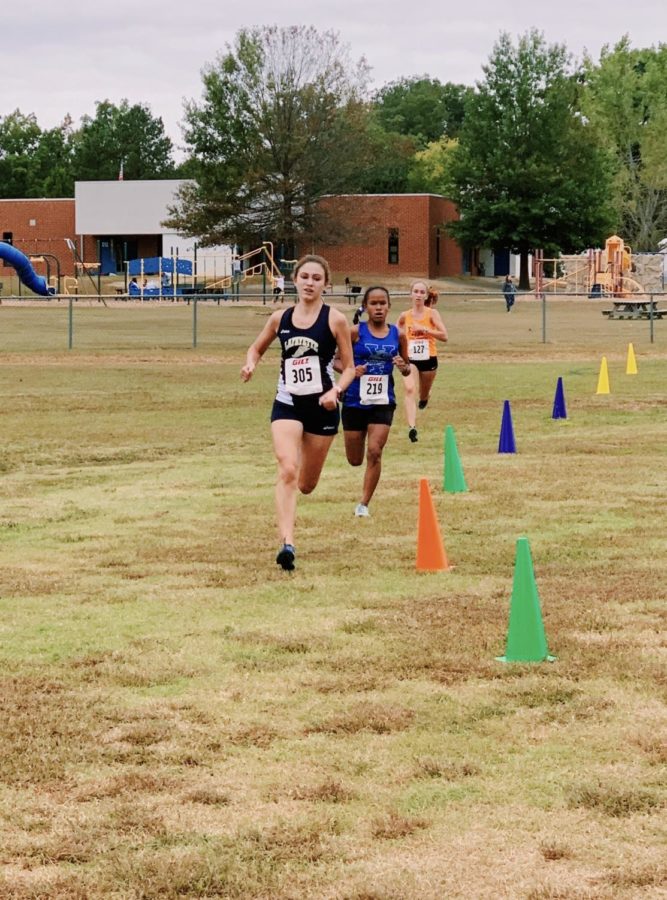 Senior Captain, Allison Crookston finishes strong at the end of the long race. A York runner tries to beat Allison in the final stretch, but Allison was able to out kick her.
