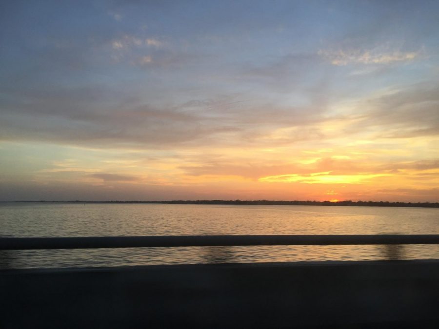 Seconds before entering the Hampton roads bridge tunnels, I captured this beautiful sunset. The sunset was brilliantly yellow and orange. My parents were going to visit my Aunt in Virginia Beach and I just happened to go along with them. 