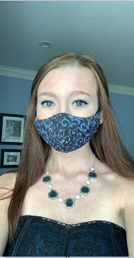 Students are told to wear their masks so that it covers both their mouth and nose.  If they are found wearing their mask incorrectly while on school property they will be corrected or sent to talk to an administrator.  Here is a student ready to learn!