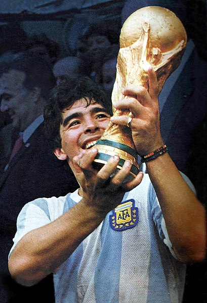 Maradona holds up the 1986 World Cup trophy after he and the Argentinian National Team defeated West Germany. 