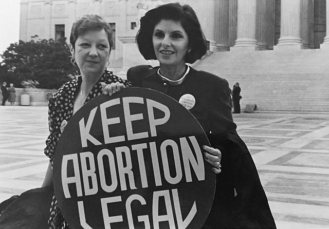 Norma McCorvey and her lawyer Gloria Allred stand in front of the Supreme Court in 1989.