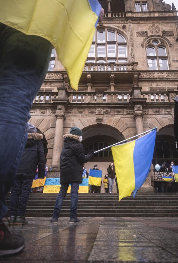A person in Bielefeld, Germany waves a Ukrainian Flag standing in solidarity with Ukraine as the war with Russia continues.