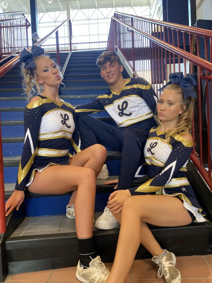 The three competition cheer captains, Emily Murphy, Braydon West, and Maya Rubin are showing off the new uniforms. The competition cheerleaders finished in third place for the first competition of the season. 