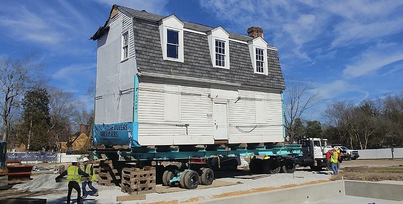 Being hoisted up on the truck, this house is excited to be moved to its new plot at Colonial Williamsburg