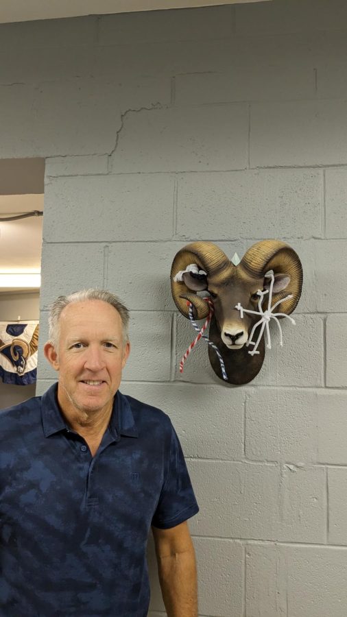 Picture of Mr. Neve with his lovely ram he displays proudly in his office. 