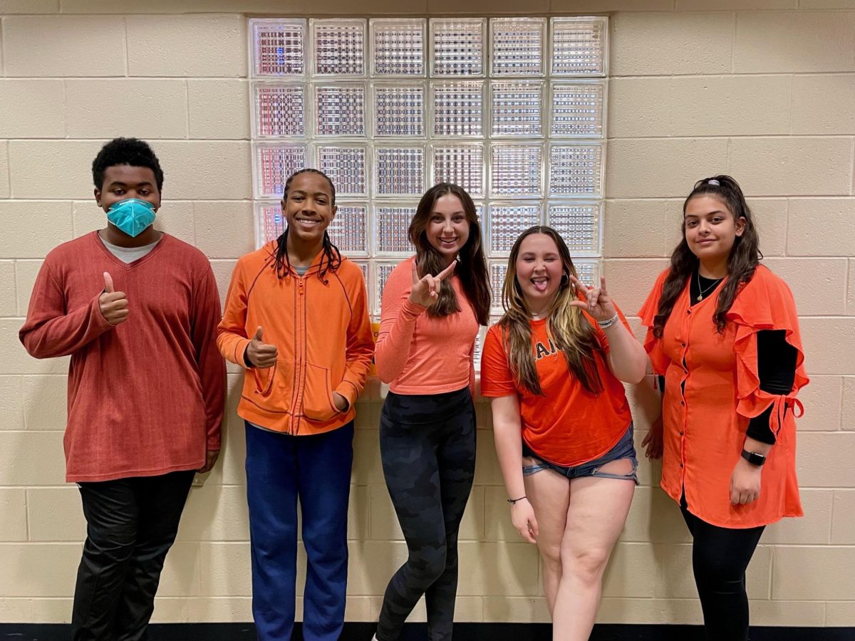 Sophomores Gabriel Rivers, Geremiah Devalle, Claudia Gilbert, and Cheyanne Wallace show their unity by wearing orange.