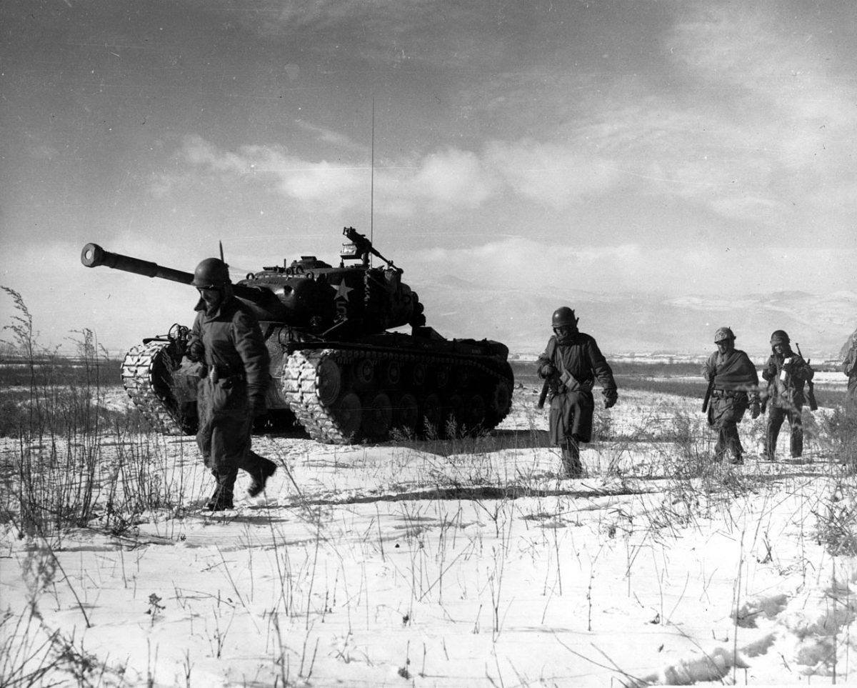 A+column+of+troops+and+armor+of+the+1st+Marine+Division+move+through+communist+Chinese+lines+during+their+successful+breakout+from+the+Chosin+Reservoir+in+North+Korea.+