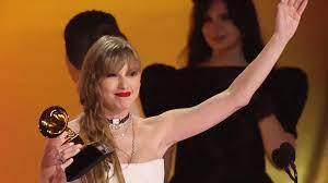 Accepting the award for Album of the Year, Taylor Swift celebrates on stage. Taylor Swift won her fourth Grammy at the 66th annual award ceremony. 