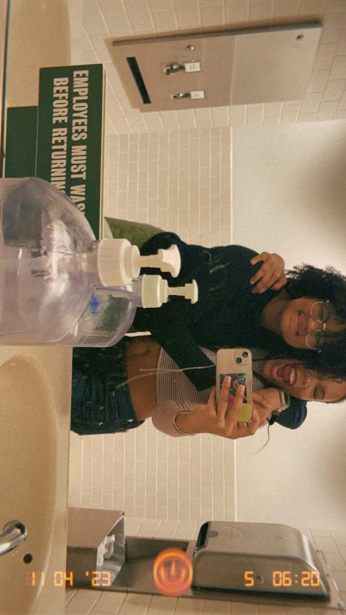 Maaliyah Outz (Left), and Aniya Everett (Right), snapping a photo in a bathroom mirror.