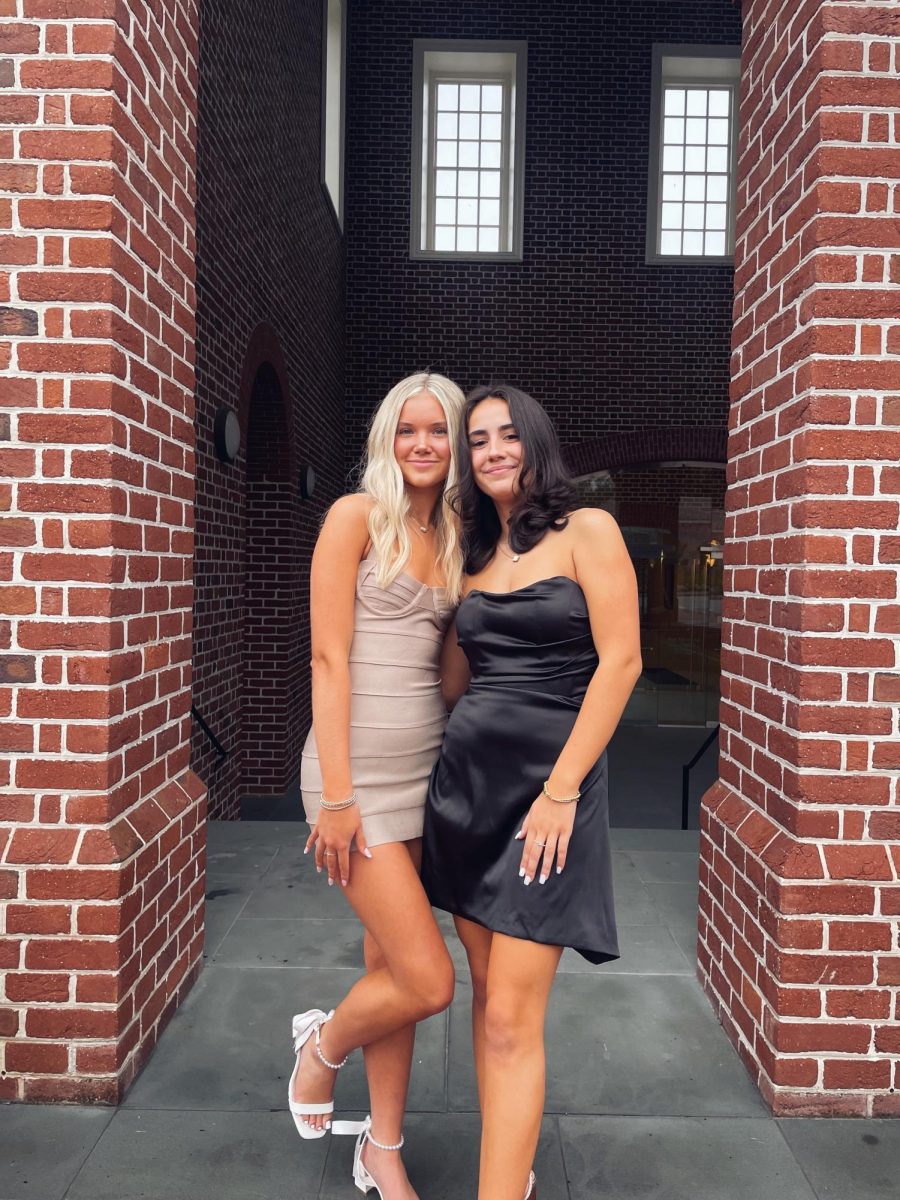 Lucia Ghoreishi and Lauren Lynn taking homecoming pictures and enjoying the night despite the bad weather.