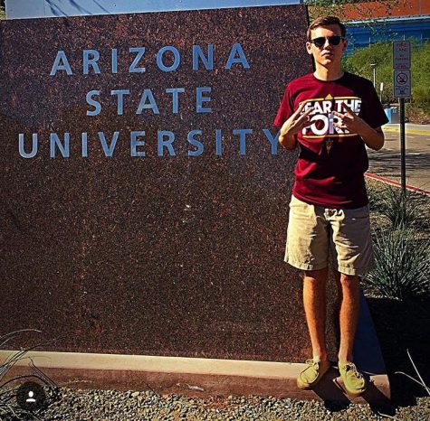 Senior Collin Corlett poses in front of ASU sign.