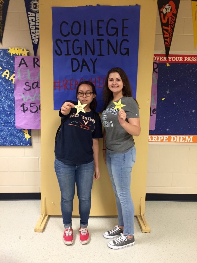 Seniors Lydia Kim and Erika Parker pose in t-shirts from their future colleges. Both Parker and Kim elected to attend in-state universities: Old Dominion University and University of Virginia respectively. 