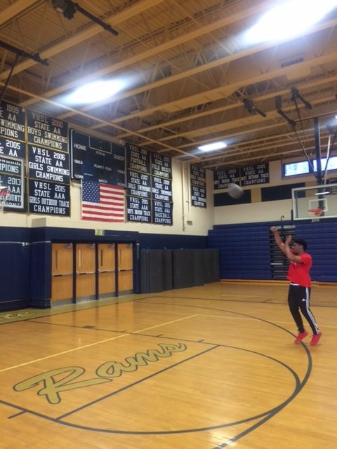 Queshon shoots from behind the 3 point line.