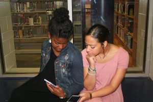 Maya Canaday and Destiny Kuhns-Gray look at pictures about light skin girls and dark skin girls
