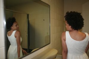 Ayanna Coan models before doing her make-up