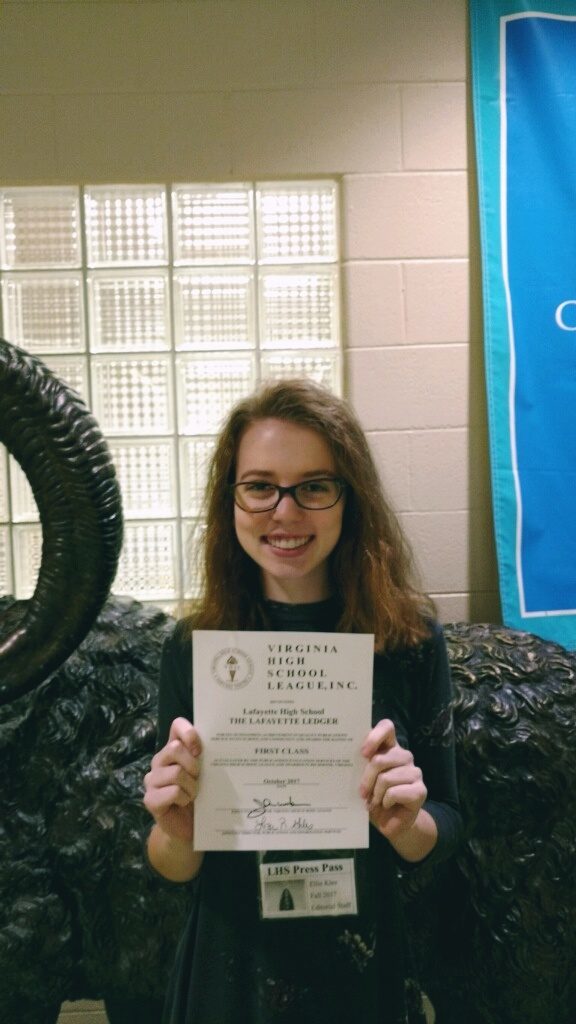 Op-Ed editor Ellie Klee shows off the Ledger's First Class award.