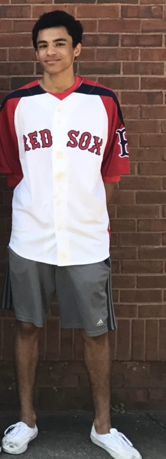 Standing pride fully against the wall turner Johnson wears his David Ortiz jersey.