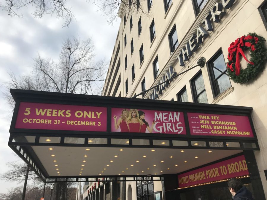 Eye-catching signs hang outside of the National Theatre to promote "Mean Girls: The Musical."