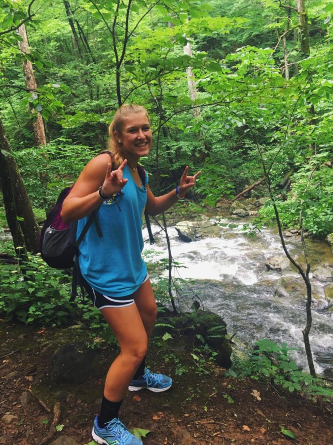 Baylie Gentry poses in front of a creek during one of her hikes. "Hiking is really fun because I get to be around nature all the time." says Baylie.