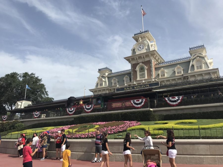 After a ten minute ride on the monorail, my family is welcomed by Disney World's very own Railroad station with a garden of flowers arranged into the shape of Mickey Mouse where there is about six to eight families at a time wait to snap a photo here before going inside of the park.