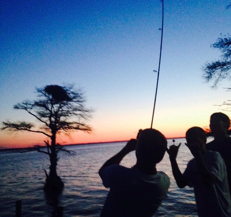 Last summer, a group of friends made the First Colony  Marina their hangout spot. Pictured above, Chase Smith reels in a big catfish after getting a bite.