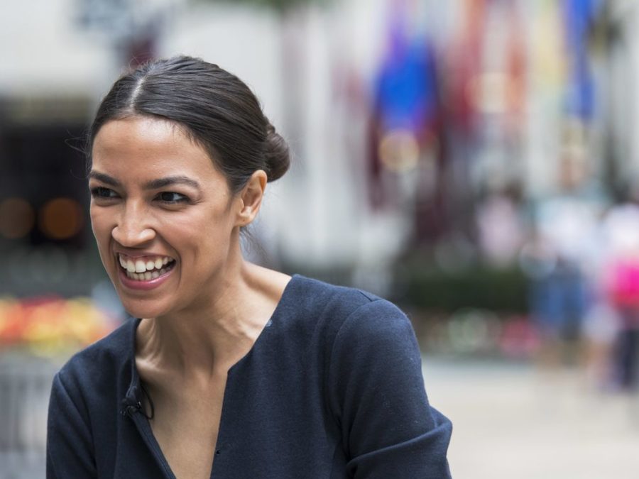 In this June 27, 2018, photo, Alexandria Ocasio-Cortez, a winner of a Democratic Congressional primary in New York speaks to a reporter in New York. Ocasio-Cortez is back on the campaign trail, but this time in the Midwest. The 28-year-old Democratic rising star is stumping for two young, progressives hoping to win Democratic primaries in Kansas and Michigan. (AP Photo/Mary Altaffer)