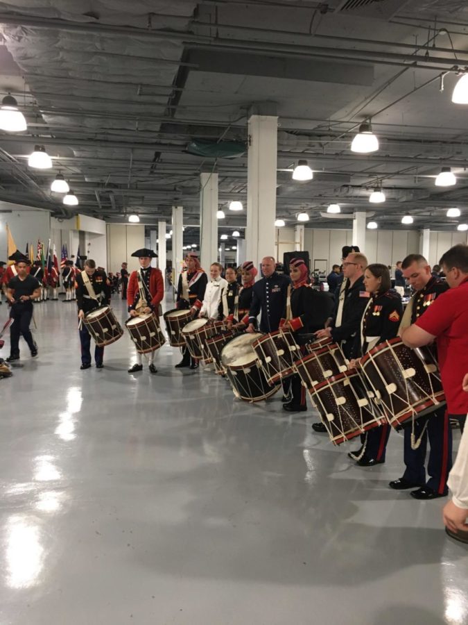 Members of the U.S. Marine Corps Band , U.S. Air Force Heritage of America Band, and Jordanian Armed Forces Combined Pipe Band play on Colonial Williamsburg drums between shows, trying to get used to the different style of instrument