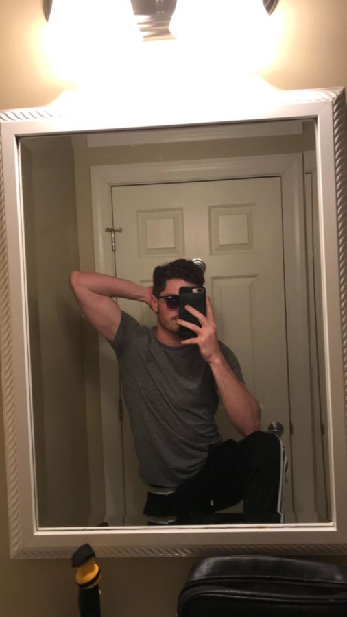 Ethan makes a funny pose in the mirror. 