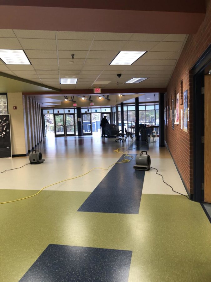 The hallway outside Ms. Peet's room, where equipment was brought to clean up the water from sprinklers.