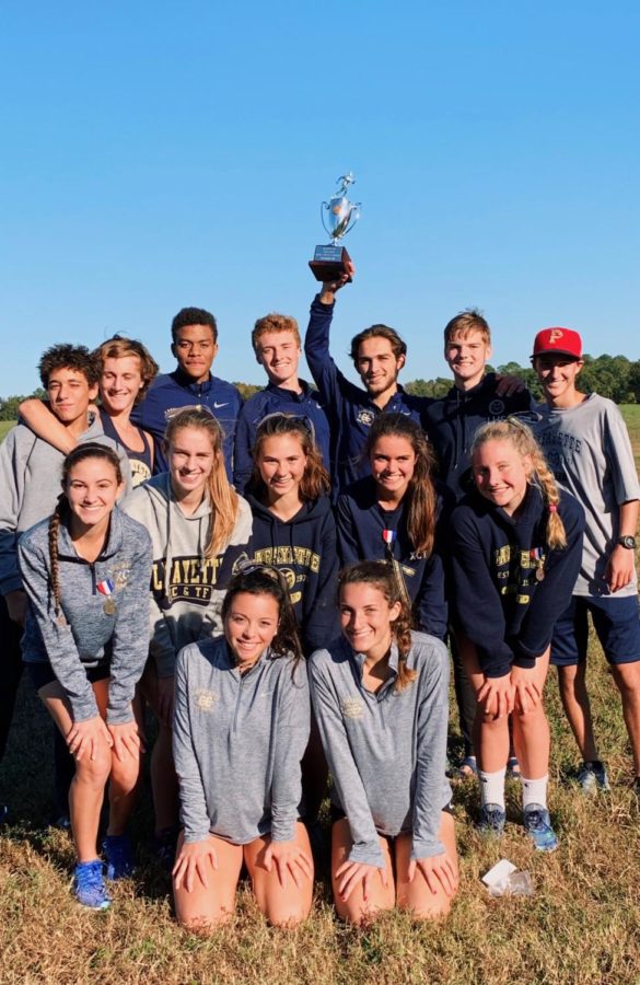 The boys and girls Lafayette Cross Country team pose together after Regionals. Zachary Barbarji holds up the boys' second place trophy.