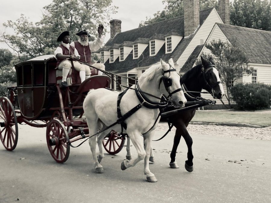 A carriage makes its way around the historical town. These carriages driven by men in colonial attire give tourists rides along the town streets and greet others along the way. 