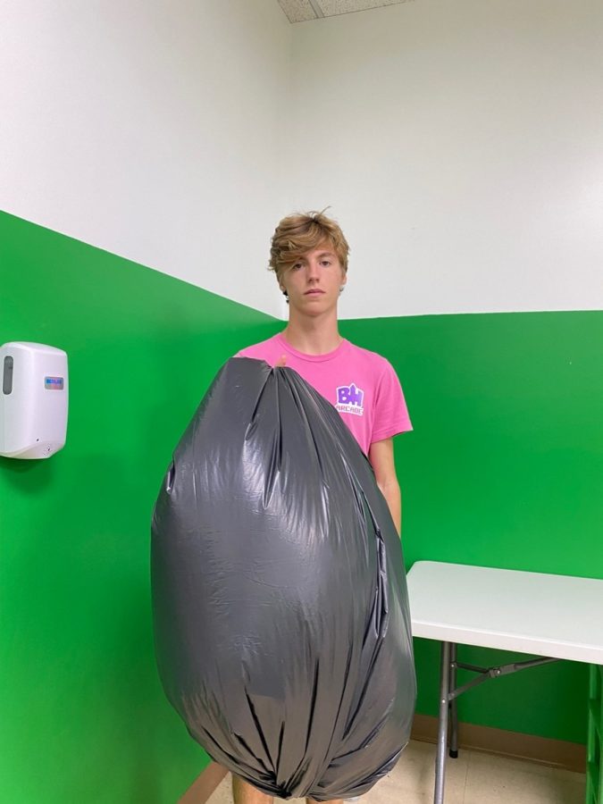 Tony taking out the trash after cleaning up the mess the birthday party he was hosting made. The bag is filled with leftover pizza, cake, and party decorations that once filled the room with joy and happiness for a 6-year-old. 