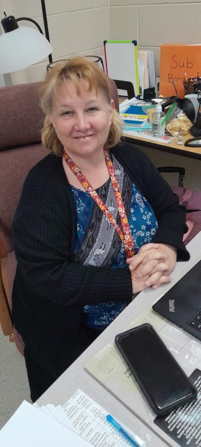 Mrs. Flint in her classroom habitat where she watches over her kids with the aid of their one-on-one adults.