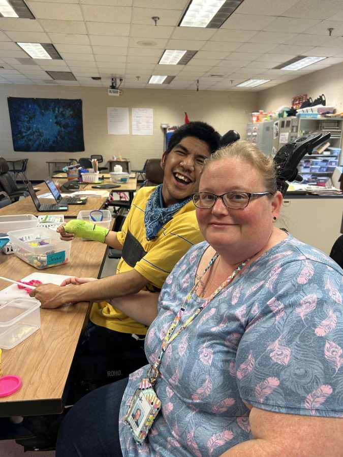 Mrs. Harris taking a break from cooking to pose with one of her students! 