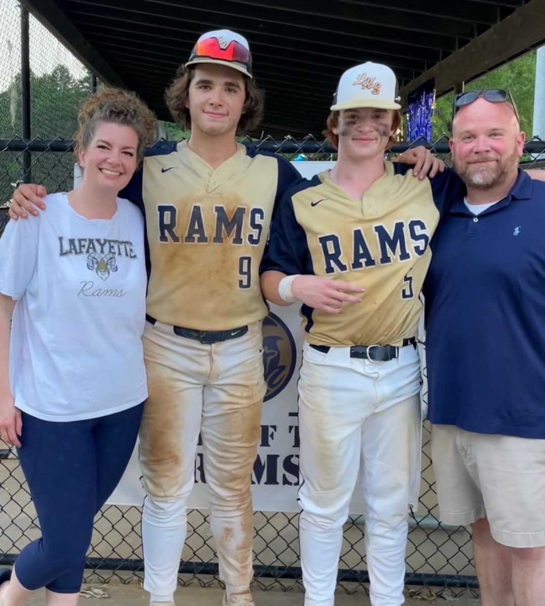 Austen, his brother, his mother, and his father pose for a picture for his brother's LHS Baseball Senior Night. 