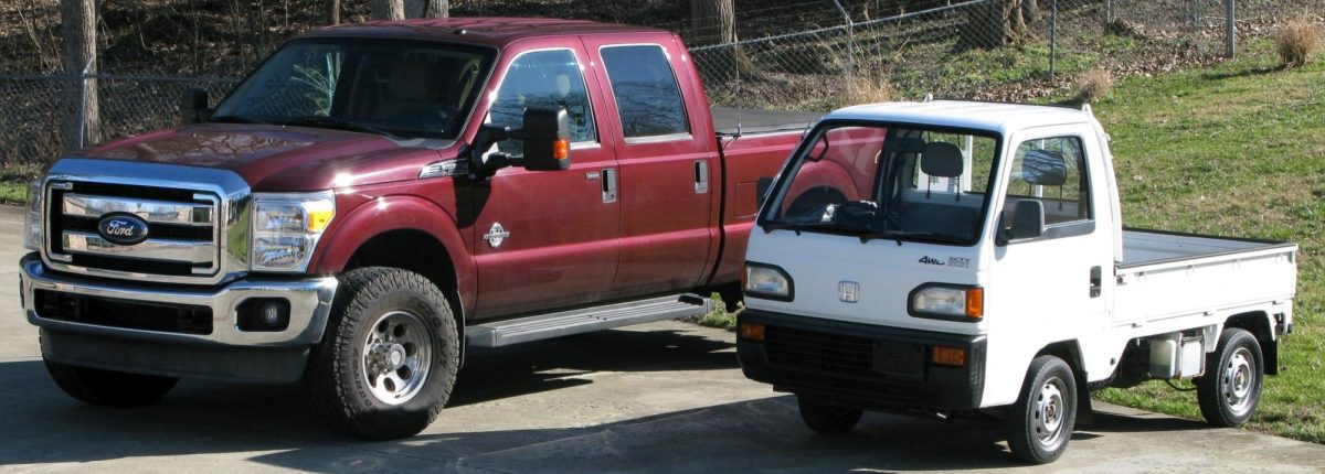 Honda Acty and F250 comparing the size next to each other.