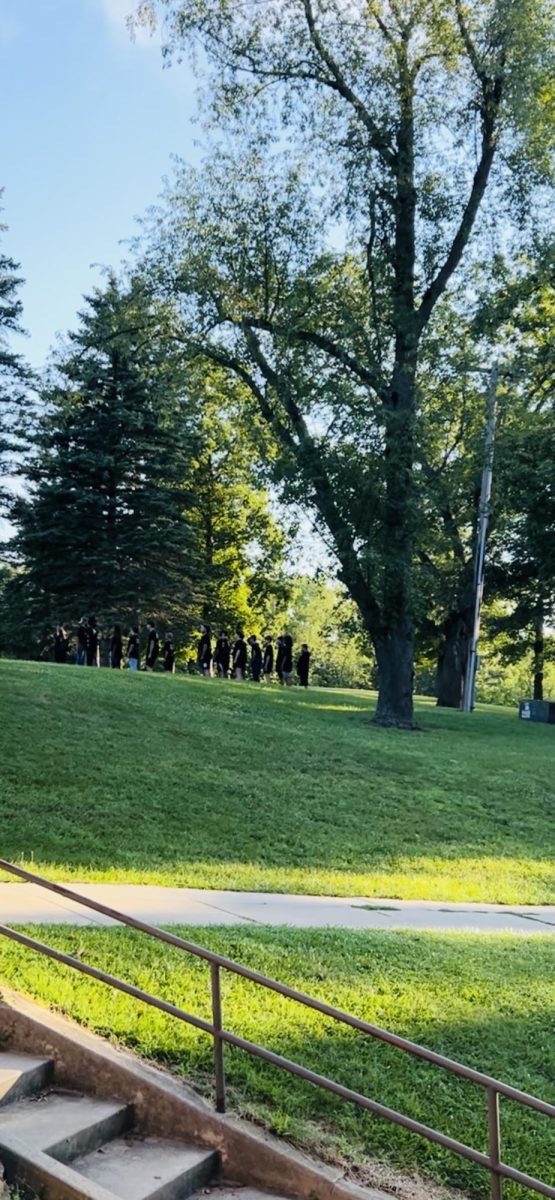 To wake the campers bright and early from a long night, the leaders march through the fields chanting