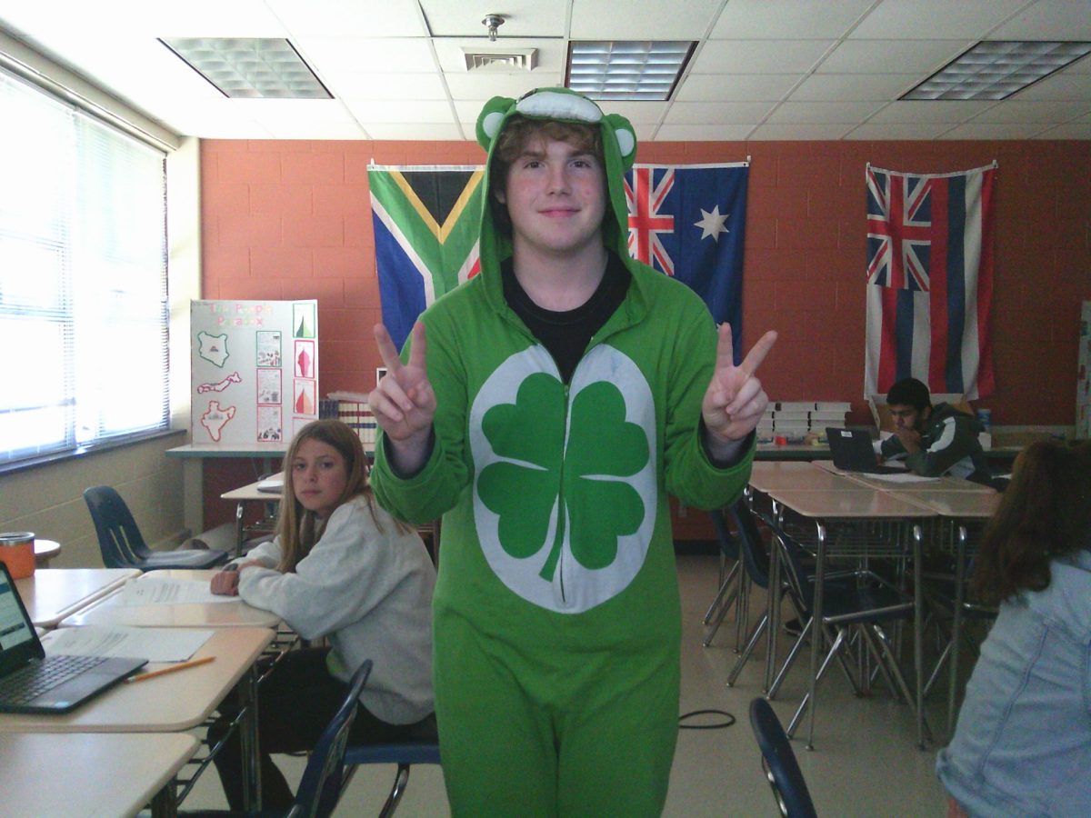 This photo shows student Dylan Knowlton throwing up peace signs while dressed as a care bear. When asked what he was he said ''I'm a care bear, duh.''