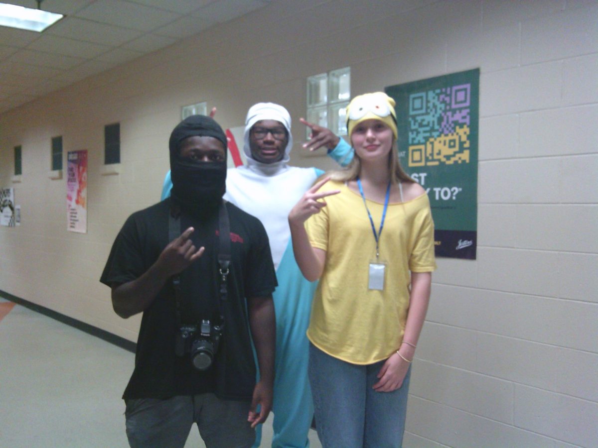 This photo features Emma Duncan, Tristin Harris, and Tyson Lasker showing off their school spirit while dressing up as different characters. 