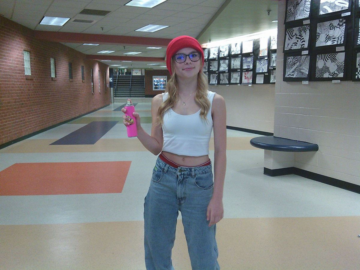 Stella Richardson poses for the camera in her subway surfer's outfit. She is holding her can of spray paint to accessorize. (Just silly string.)